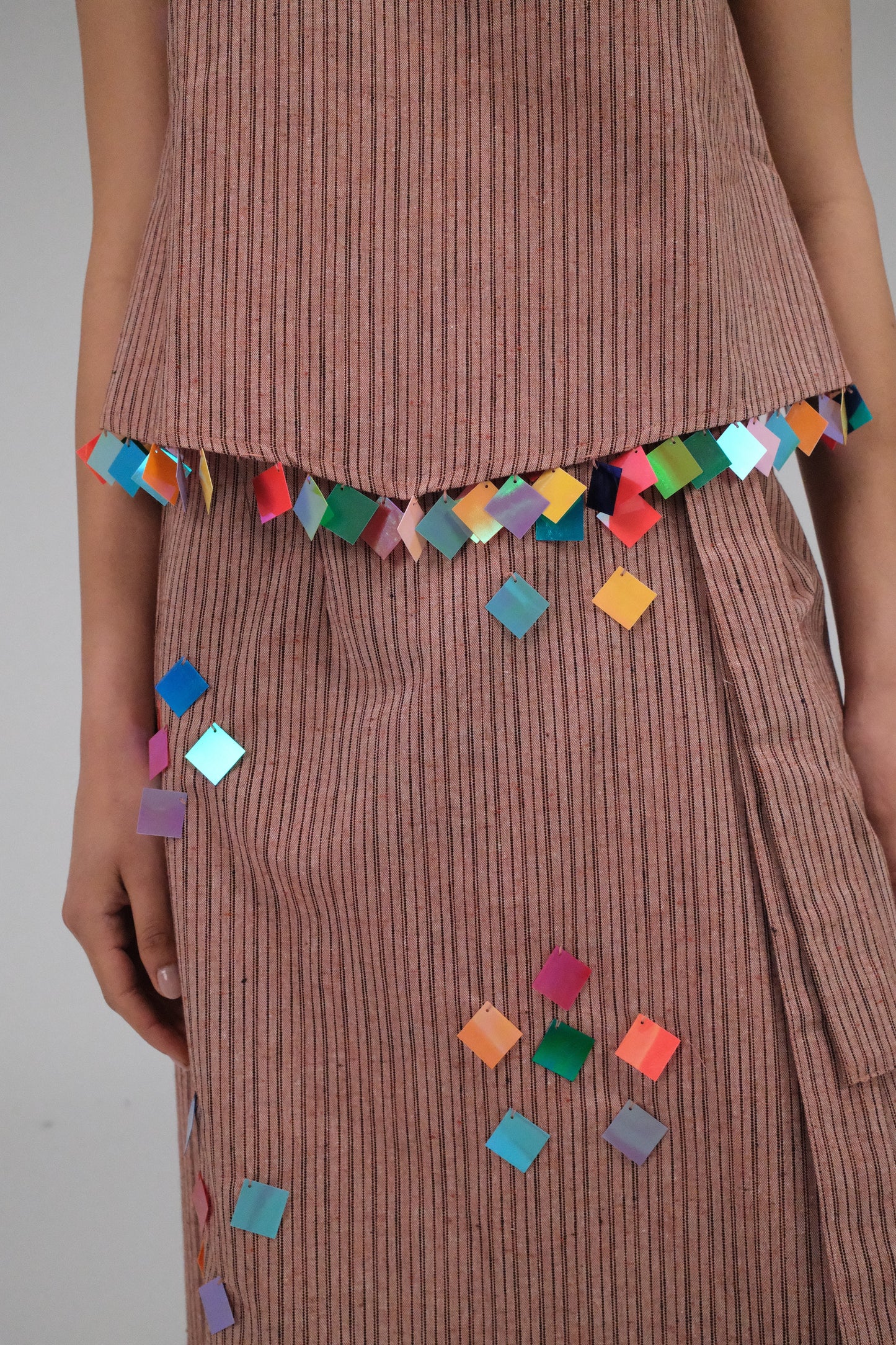 THE LIGHT ORANGE TOP WITH COINS