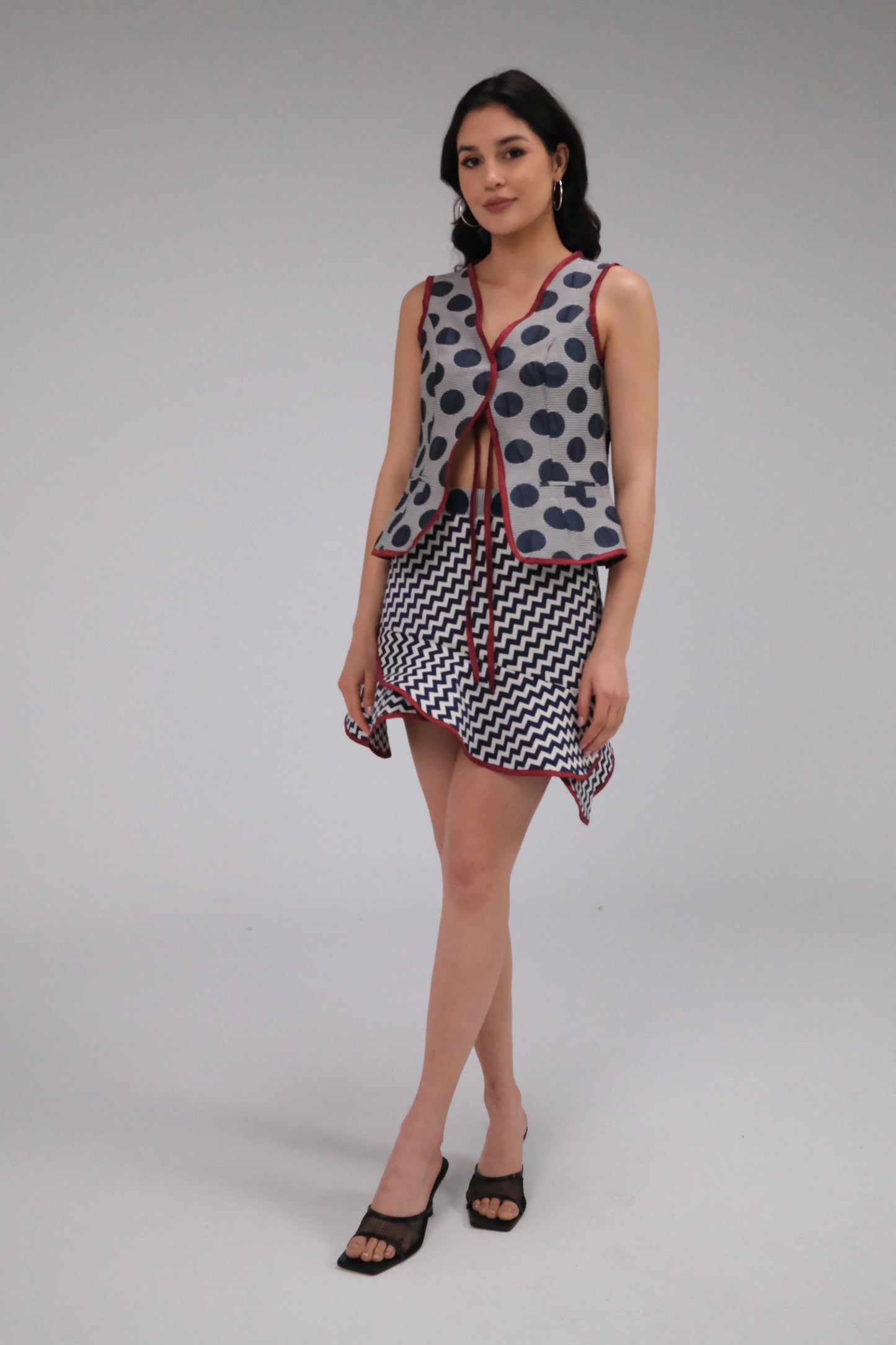 THE ZIGZAG ASYMMETRICAL MINI SKIRT WITH BURGUNDY TRIM