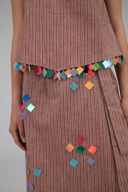 THE LIGHT ORANGE TOP WITH COINS