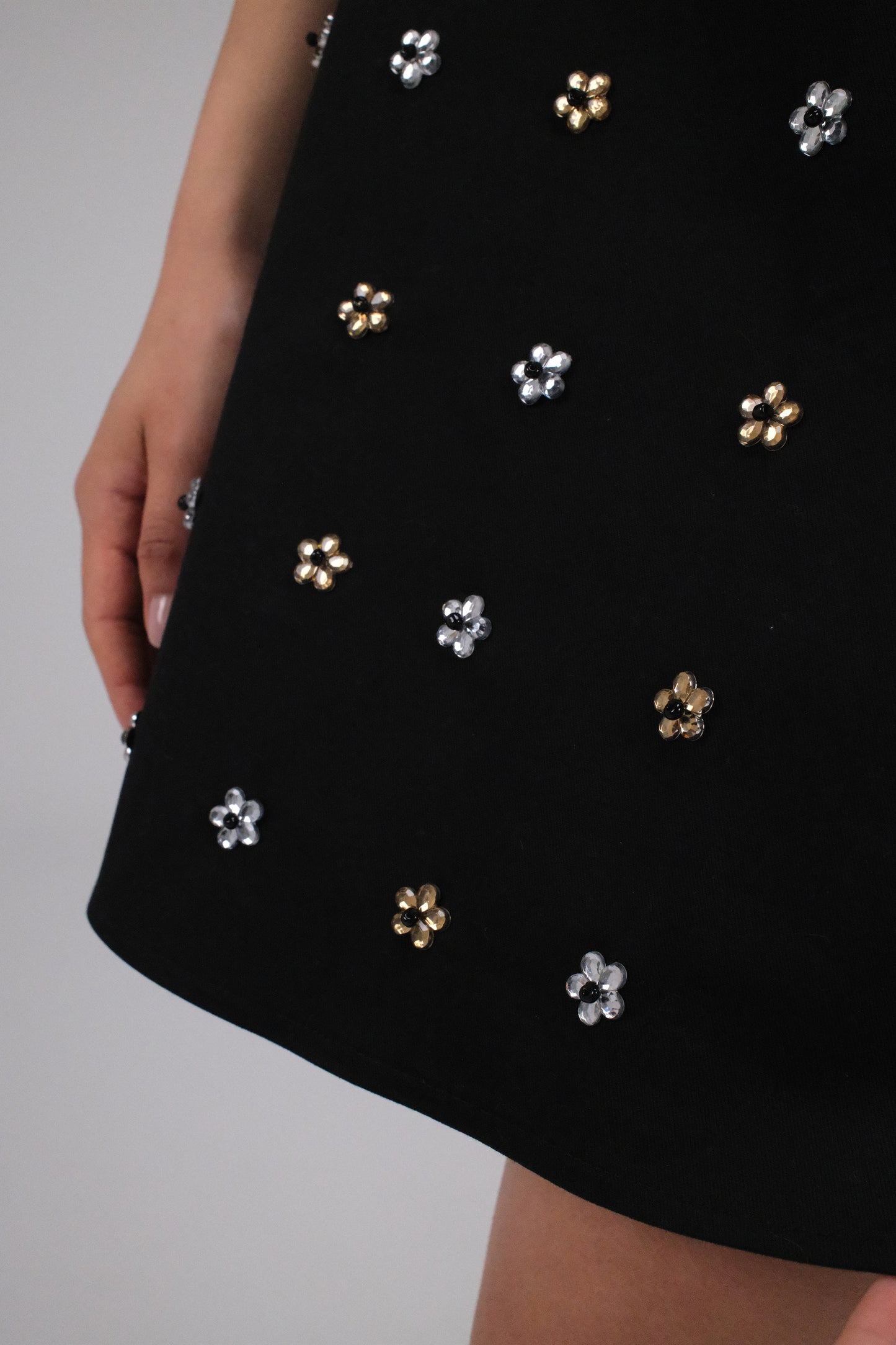 THE BLACK GABARDINE ALINE MINI SKIRT WITH FLOWER CRYSTALS
