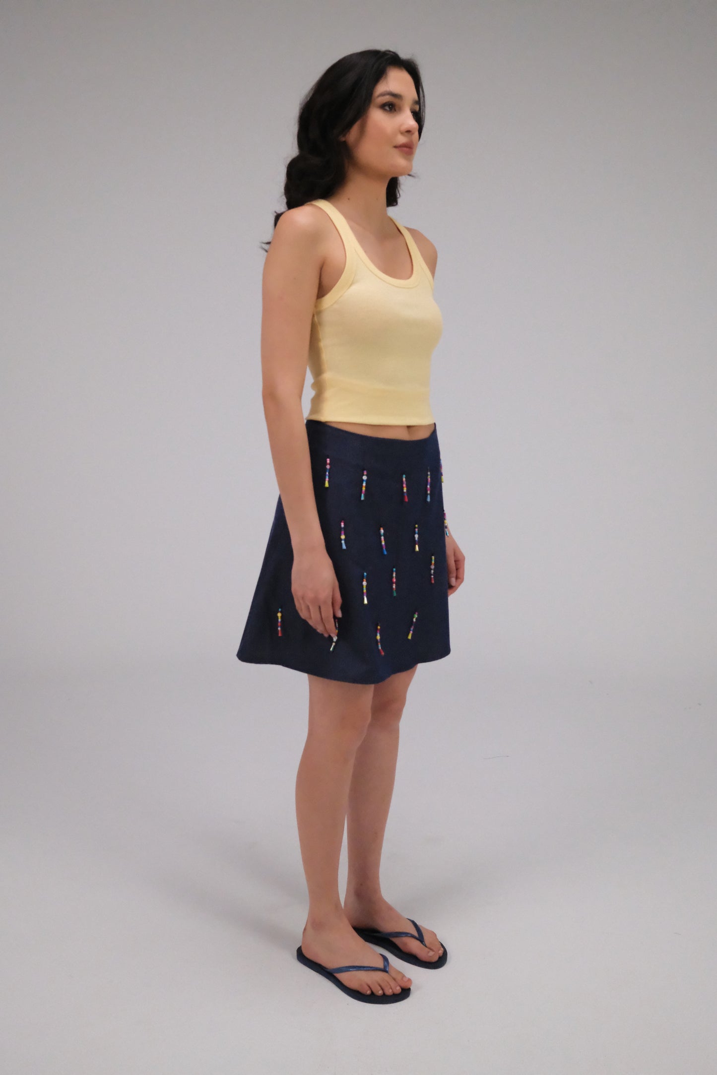 THE DENIM ALINE MINI SKIRT WITH DANGLING BEADS